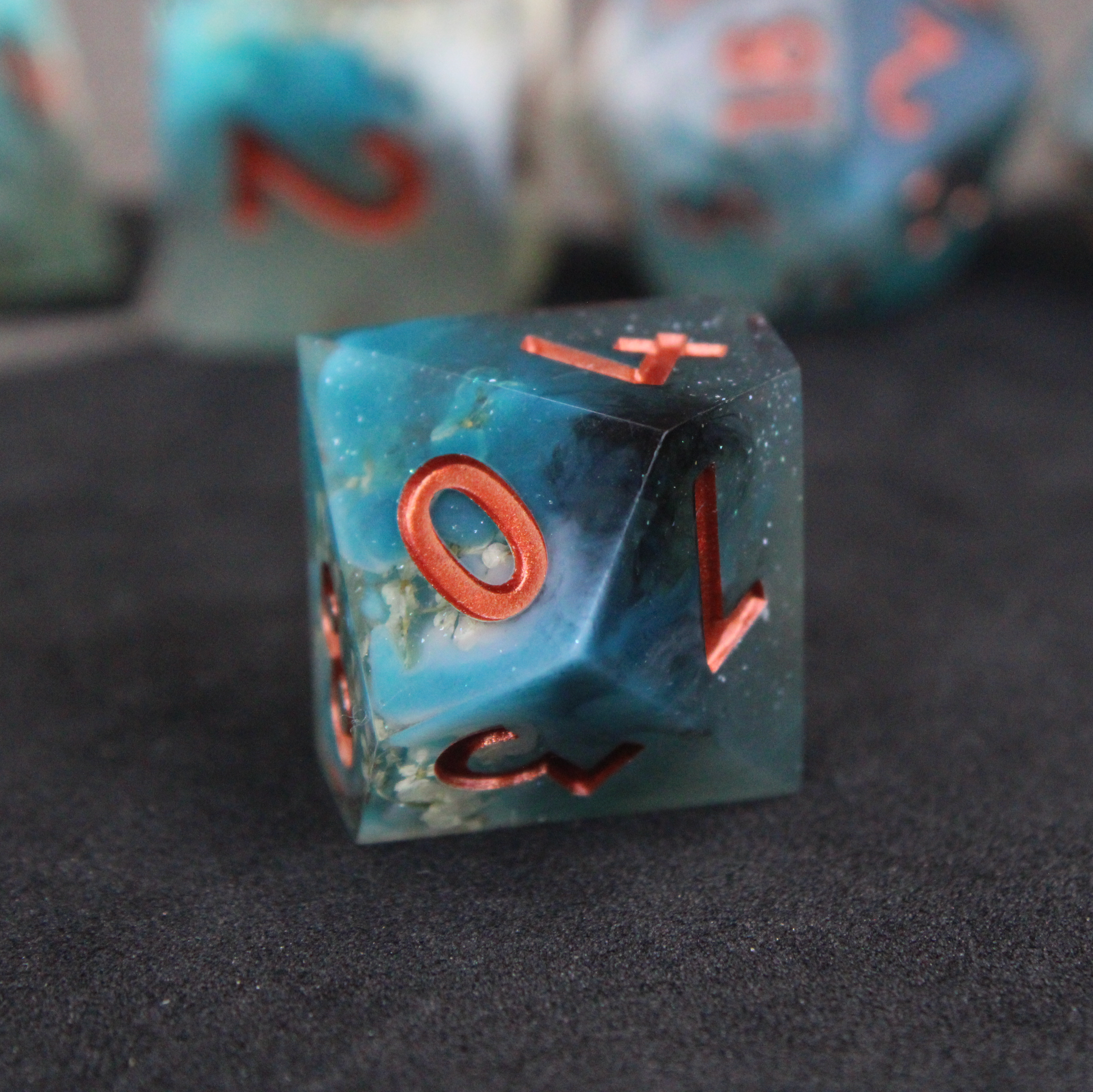 Blue sharp edge dice with white flowers inside. Used in tabletop roleplaying games like Dungeons & Dragons, DND, D&D, Pathfinder.