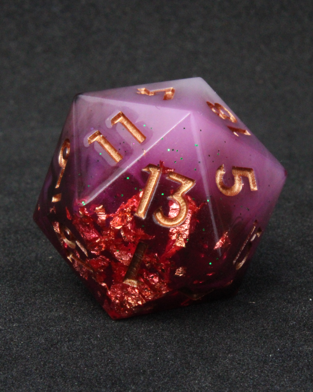 Black, pink and red resin sharp edge dice. These polyhedral dice are used to play TTRPGs like Dungeons & Dragons / D&D / DND and Pathfinder.