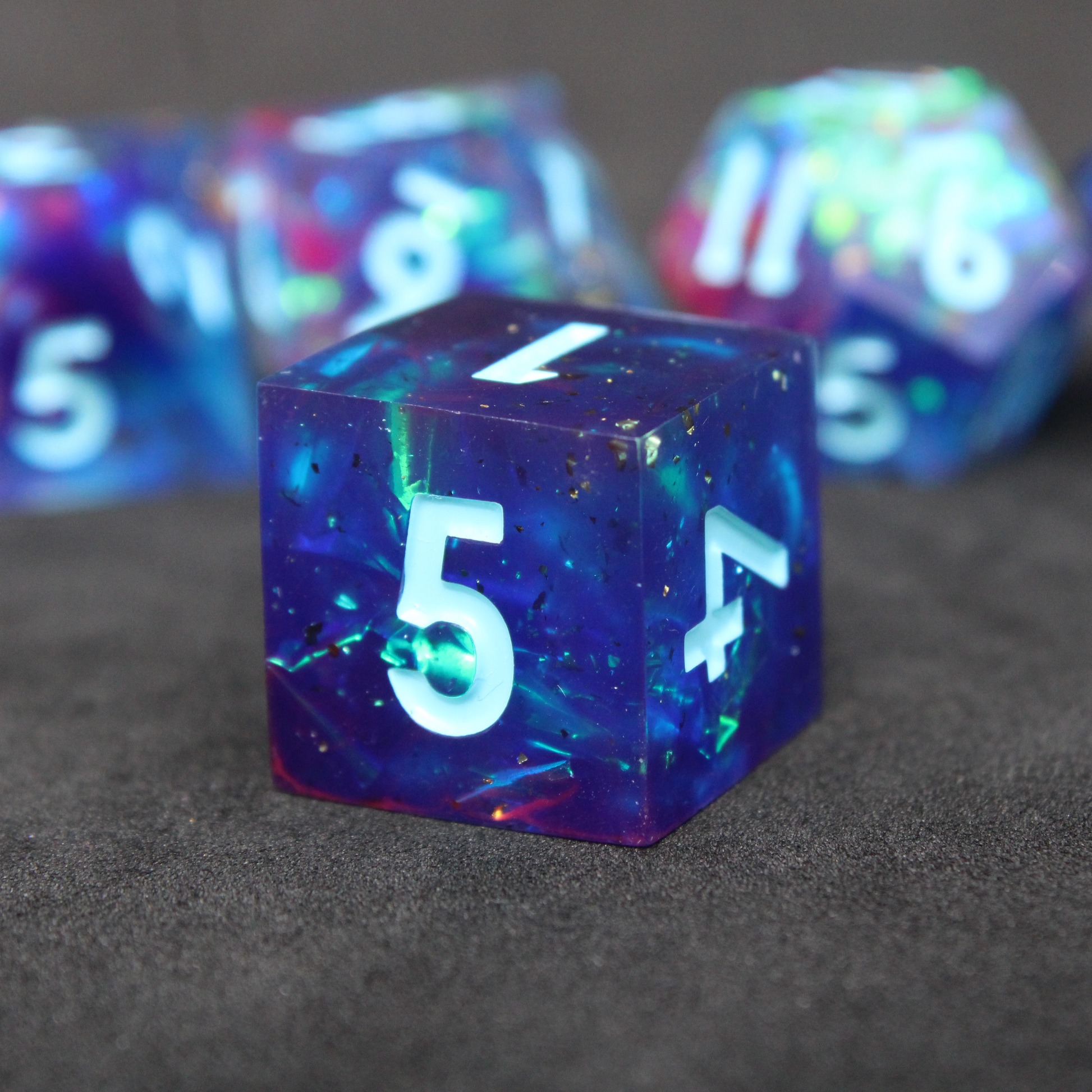 Purple and blue sharp edge dnd dice set. The dice set is used for playing TTRPGs like Dungeons & Dragons / D&D and Pathfinder.
