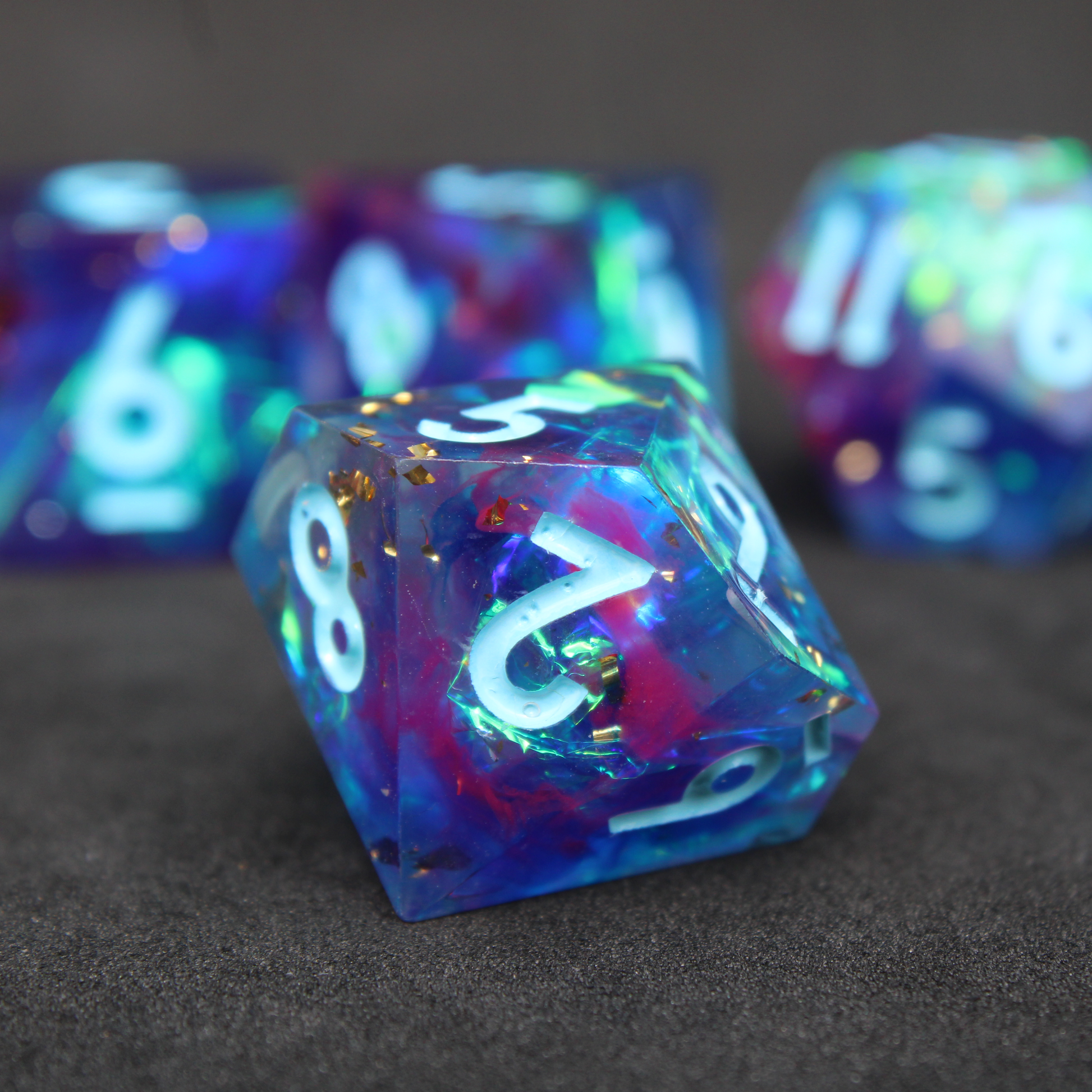 Purple and blue sharp edge dnd dice set. The dice set is used for playing TTRPGs like Dungeons & Dragons / D&D and Pathfinder.