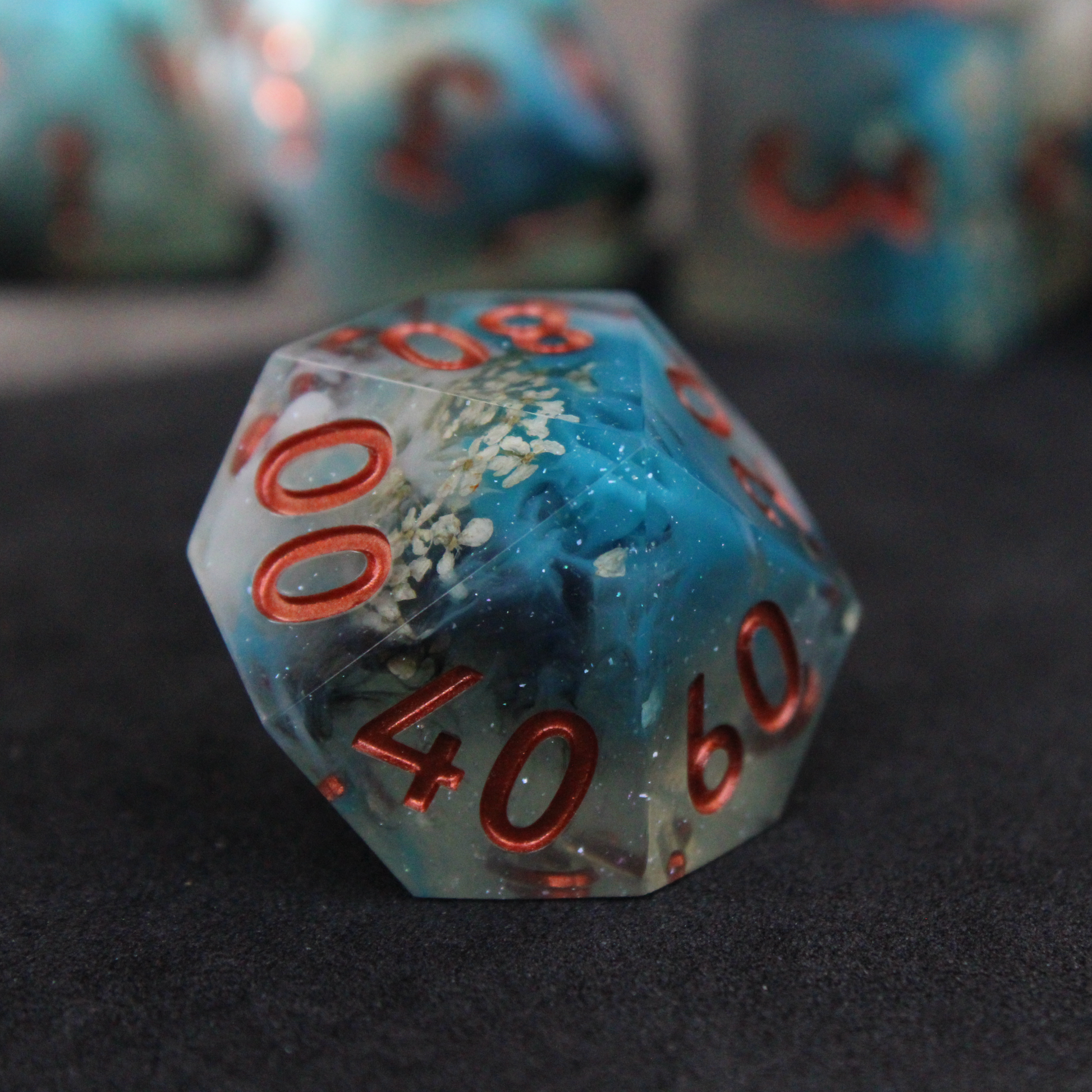 Blue sharp edge dice with white flowers inside. Used in tabletop roleplaying games like Dungeons & Dragons, DND, D&D, Pathfinder.