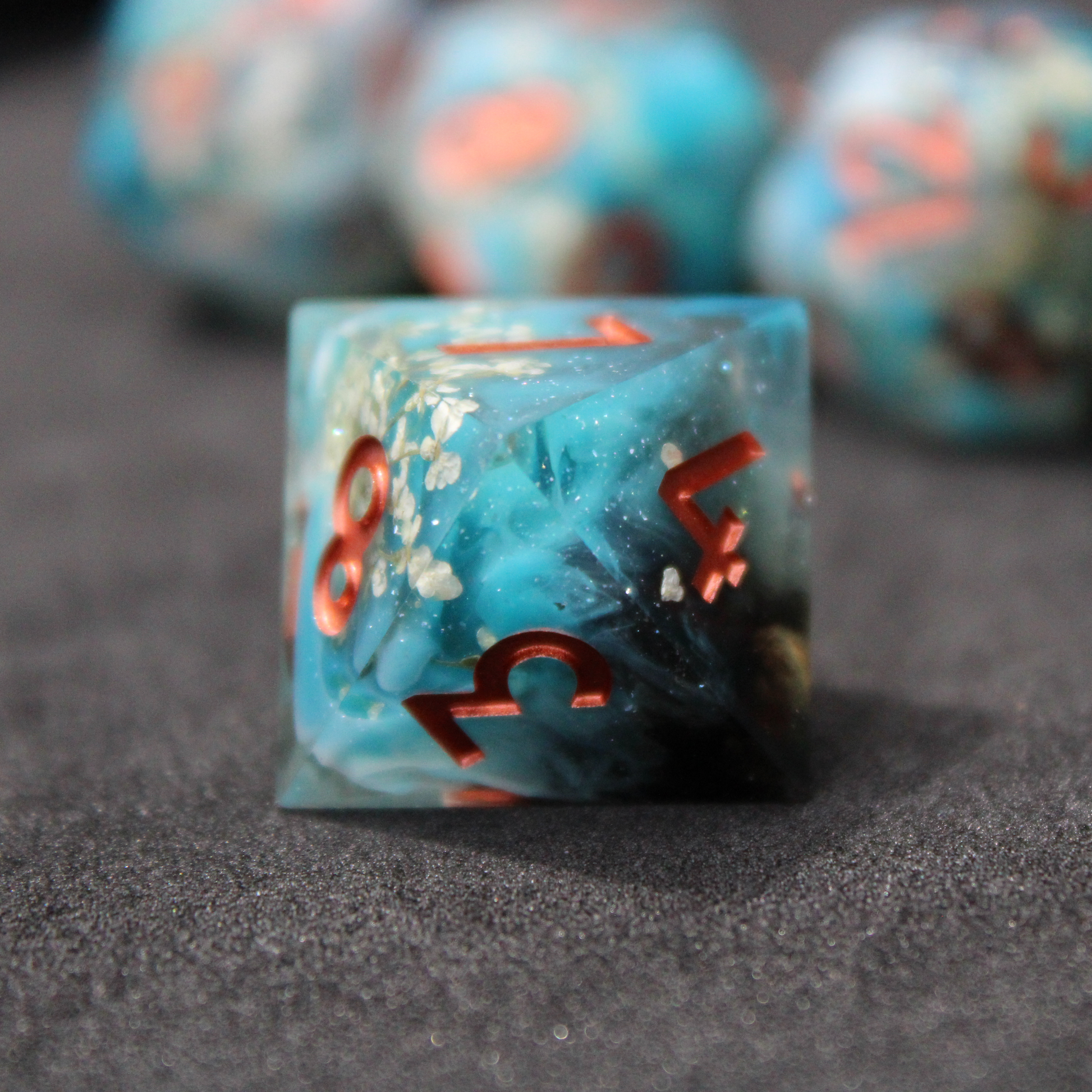 Blue sharp edge dice with white flowers inside. Used in tabletop roleplaying games like Dungeons & Dragons, DND, D&D, Pathfinder.