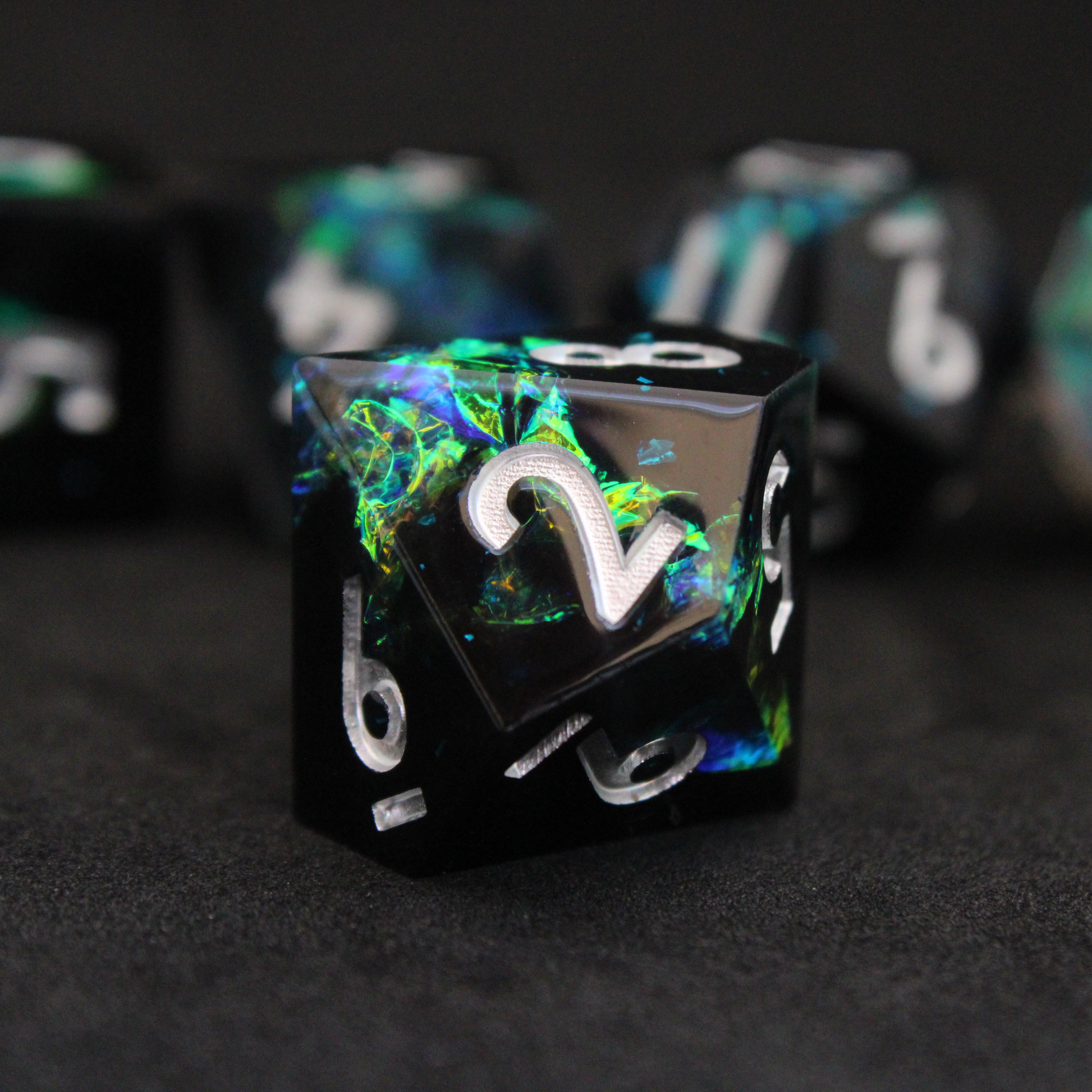 Black and blue sharp edge dnd dice set made of resin and made to look like lightning in a bottle. These polyhedral dice are used to play TTRPGs like Dungeons & Dragons / D&D and Pathfinder.