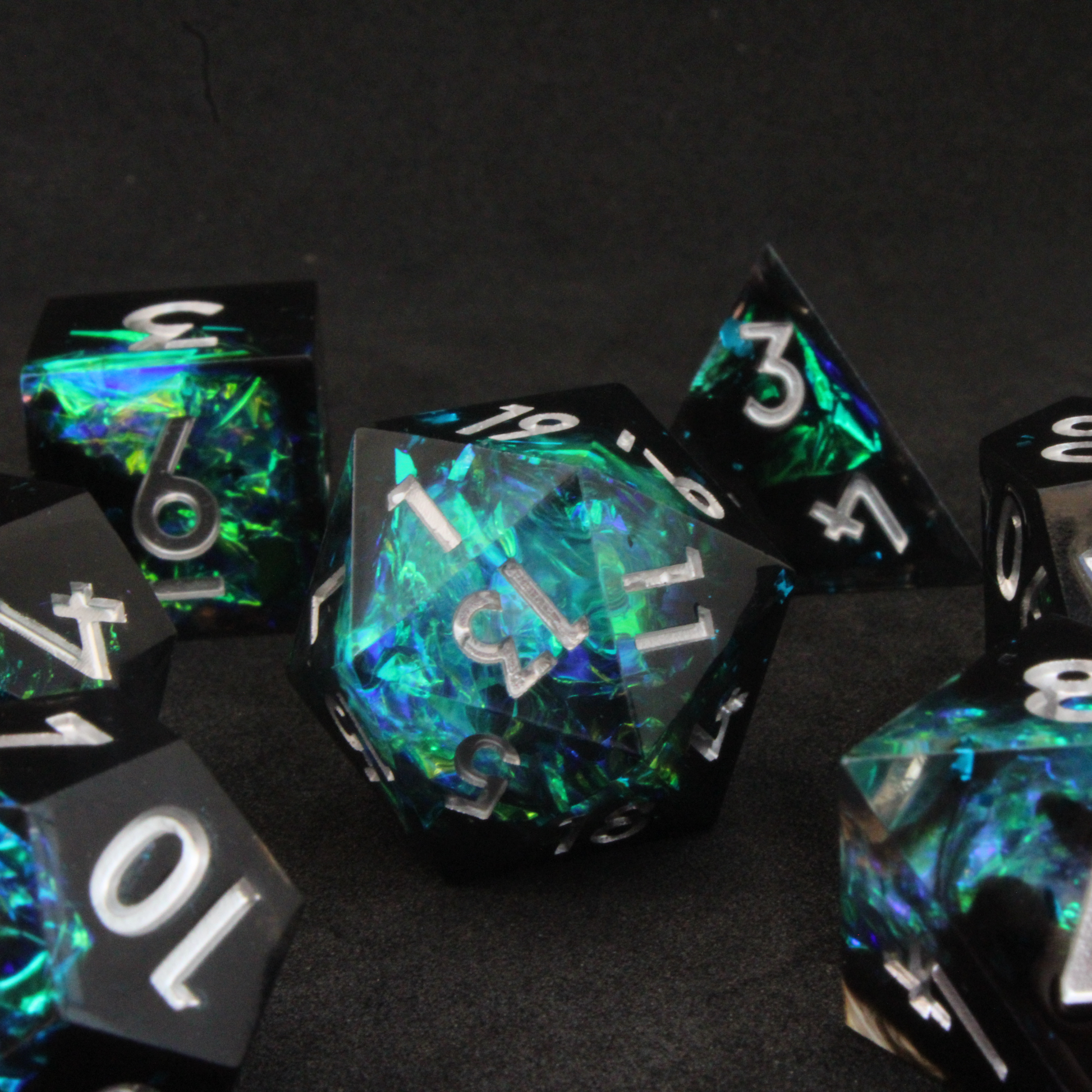 Black and blue sharp edge dnd dice set made of resin and made to look like lightning in a bottle. These polyhedral dice are used to play TTRPGs like Dungeons & Dragons / D&D and Pathfinder.