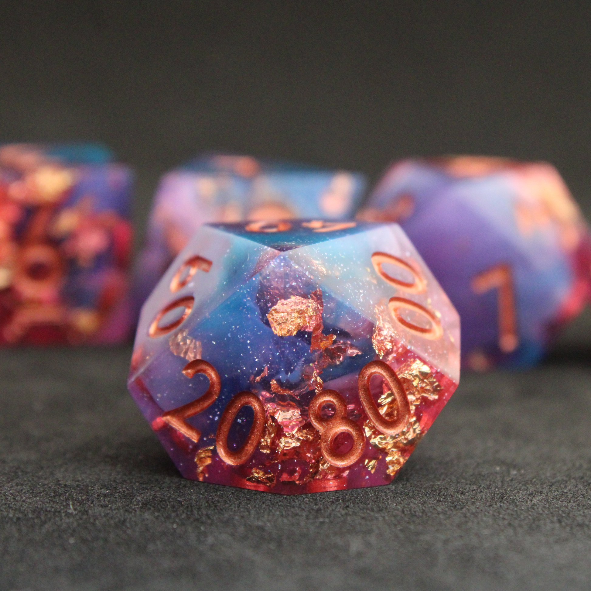 Set of blue, pink and purple sharp edge dnd dice. These polyhedral dice are used for tabletop roleplaying games like Dungeons & Dragons / D&D and Pathfinder.