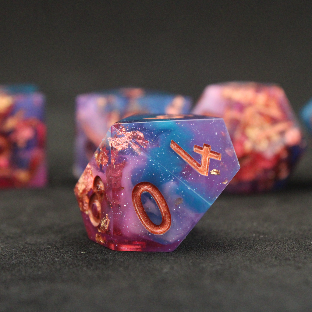 Set of blue, pink and purple sharp edge dnd dice. These polyhedral dice are used for tabletop roleplaying games like Dungeons & Dragons / D&D and Pathfinder.