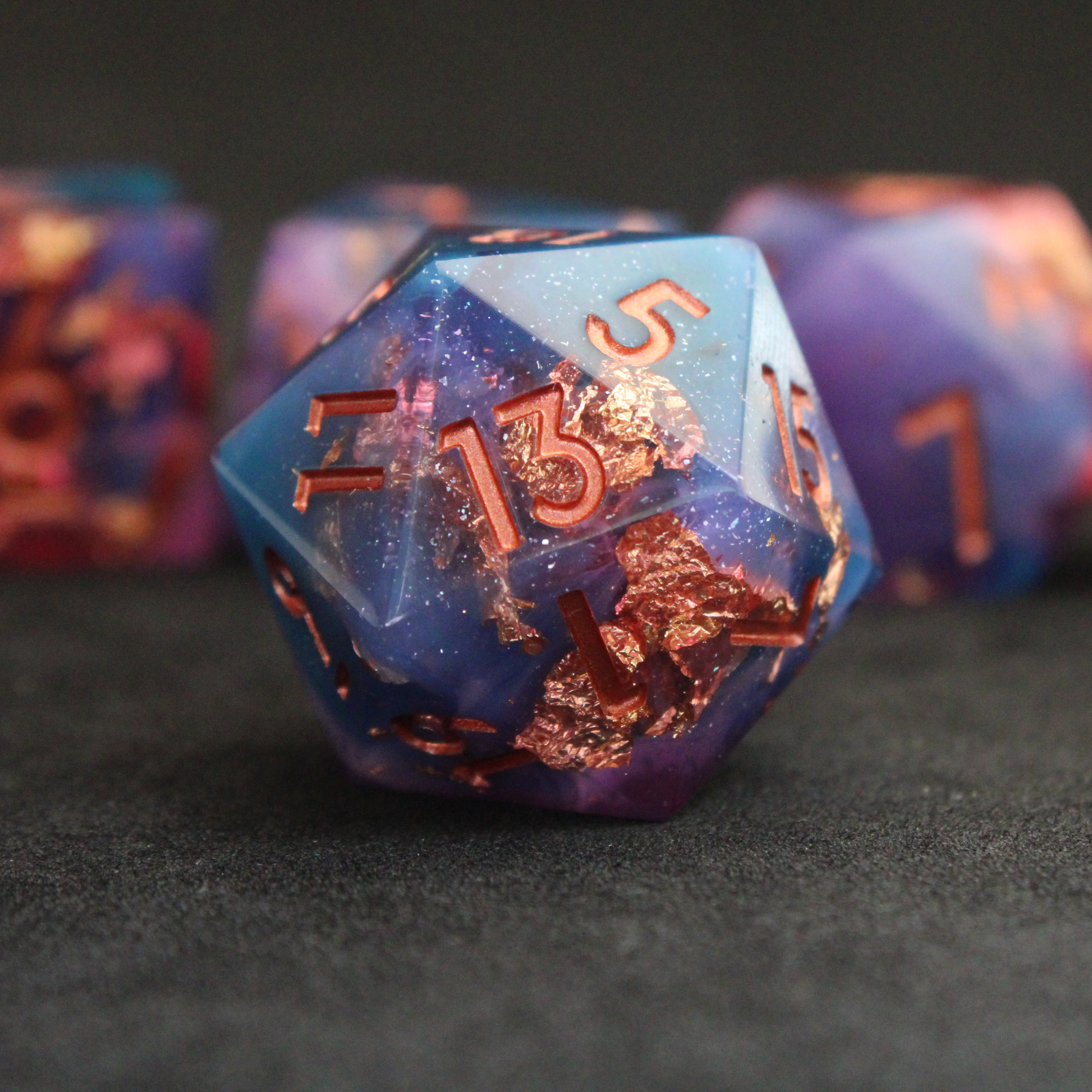 Set of blue, pink and purple sharp edge dnd dice. These polyhedral dice are used for tabletop roleplaying games like Dungeons & Dragons / D&D and Pathfinder.