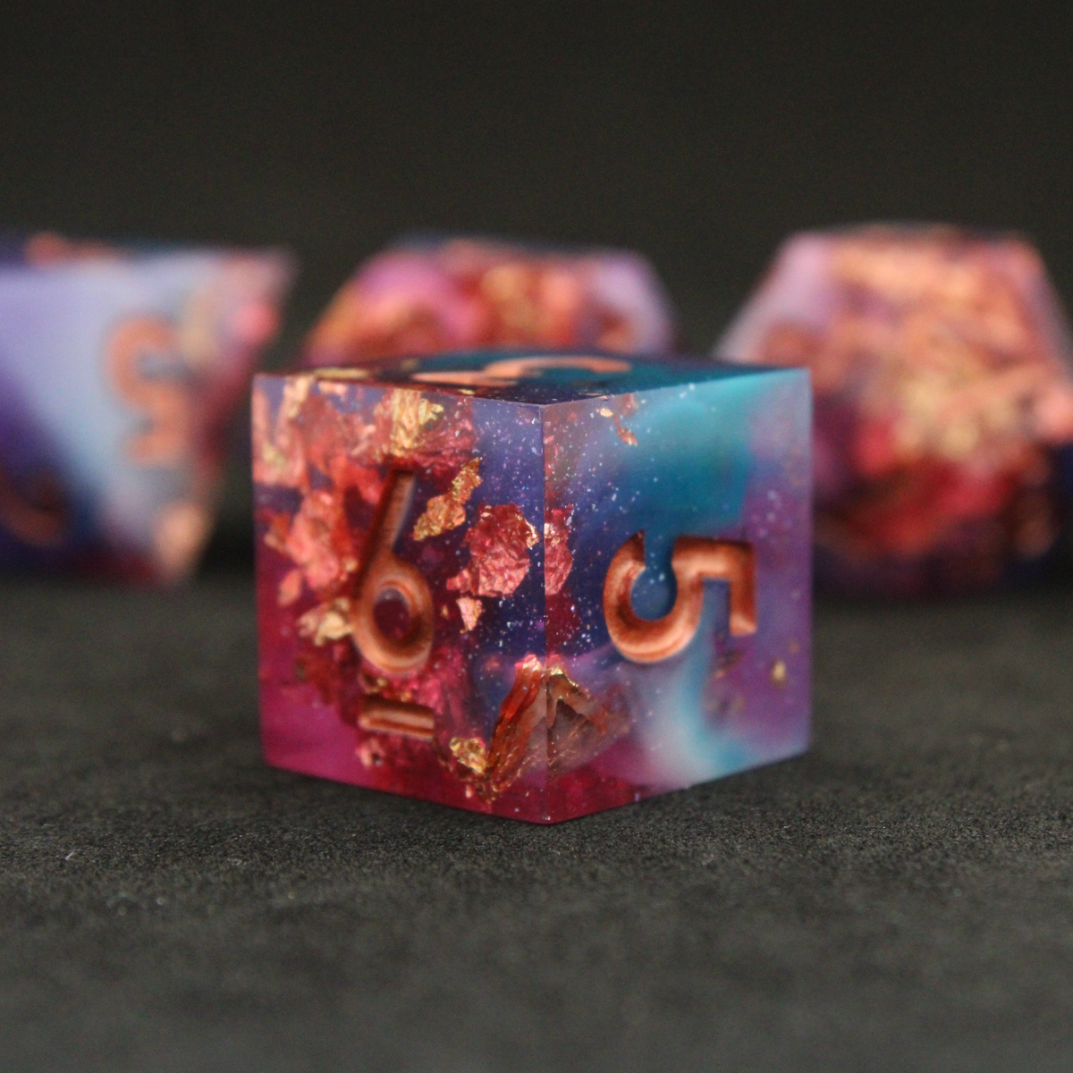Set of blue, pink and purple sharp edge dnd dice. These polyhedral dice are used for tabletop roleplaying games like Dungeons & Dragons / D&D and Pathfinder.