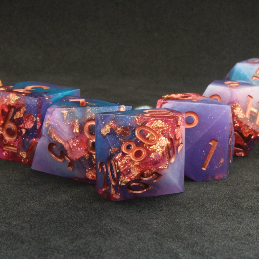 Set of blue, pink and purple sharp edge dnd dice. These polyhedral dice are used for tabletop roleplaying games like Dungeons & Dragons / D&D and Pathfinder.