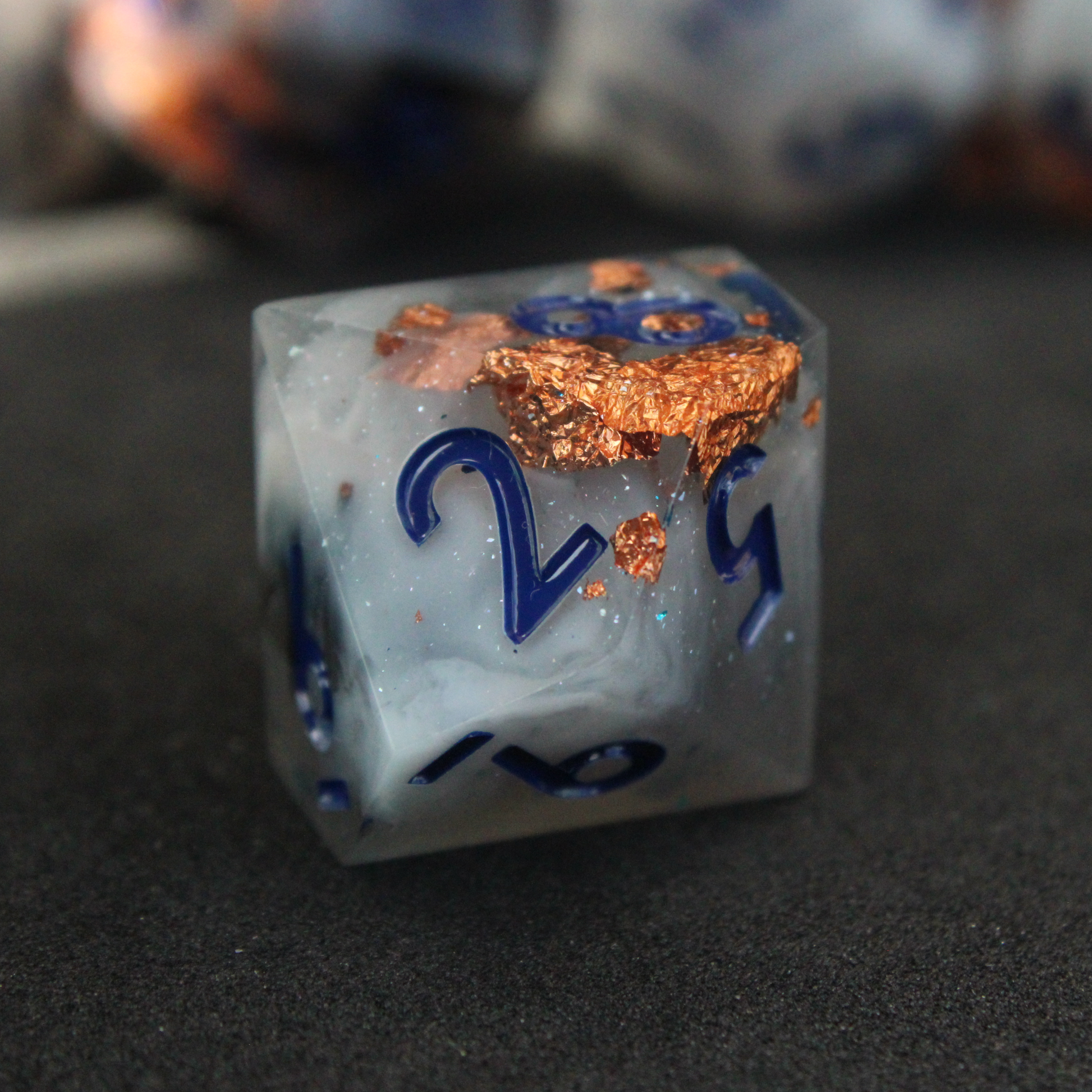 Blue grey sharp edge dnd dice used for playing tabletop roleplaying games like Dungeons & Dragons / D&D and Pathfinder. 
