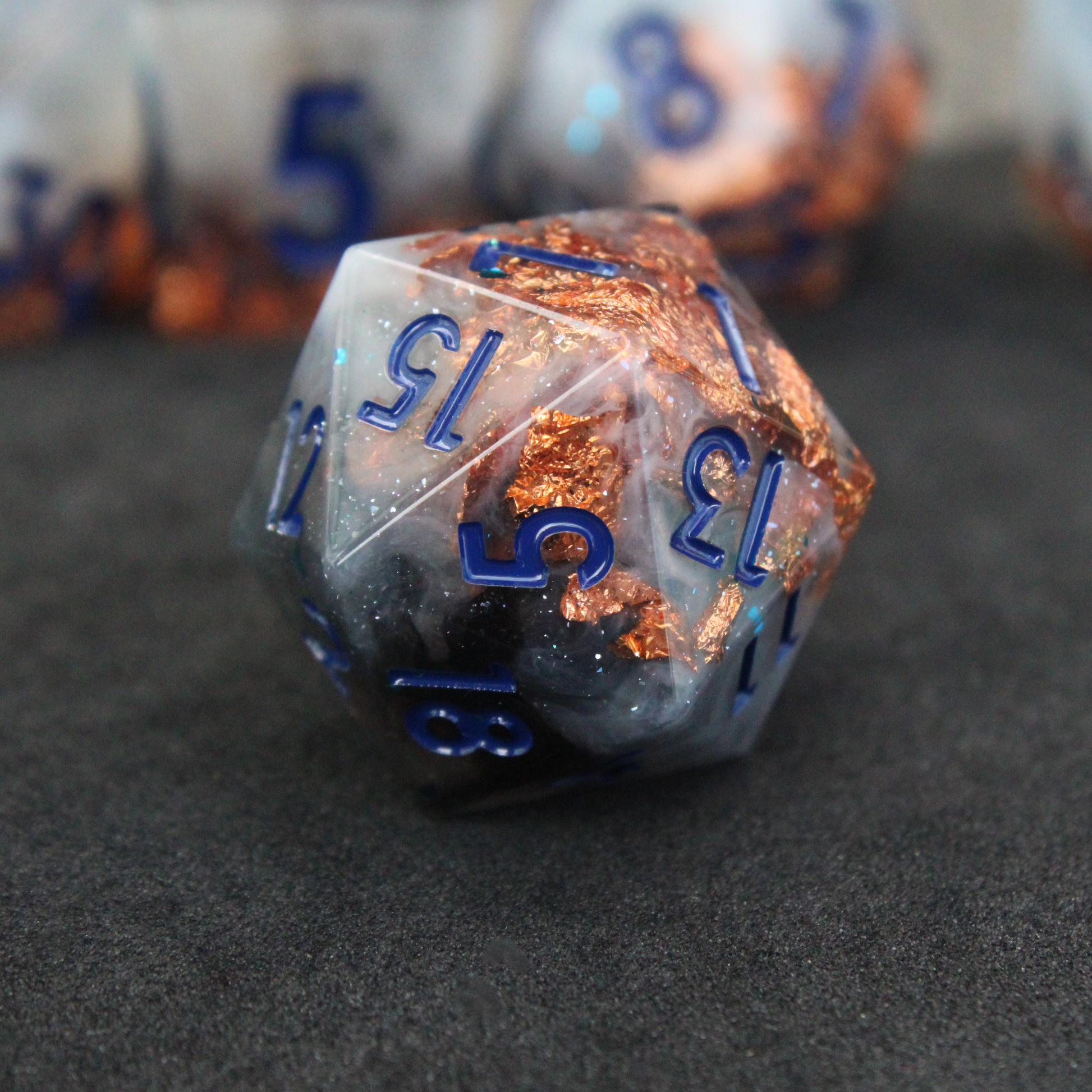 Blue grey sharp edge dnd dice used for playing tabletop roleplaying games like Dungeons & Dragons / D&D and Pathfinder. 