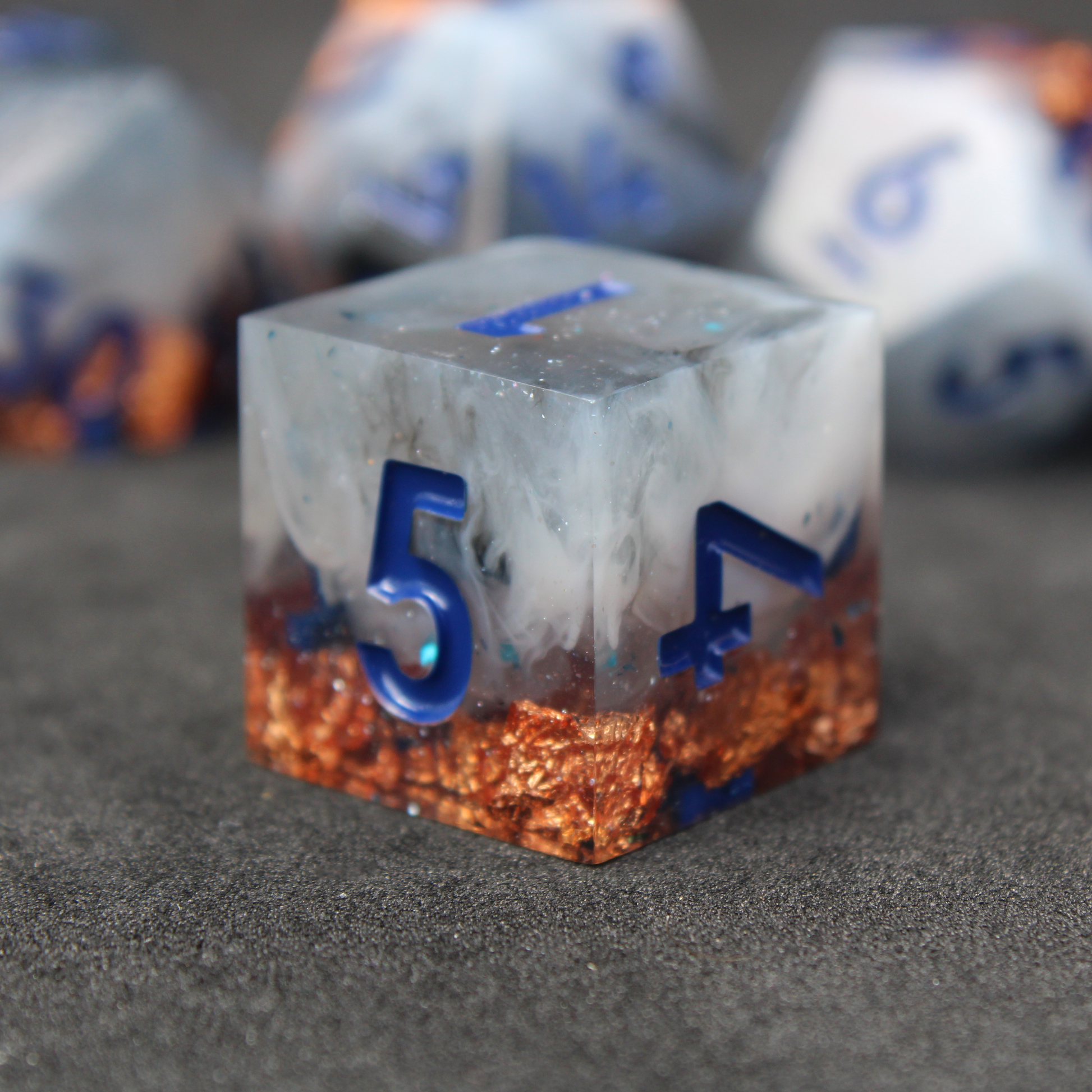 Blue grey sharp edge dnd dice used for playing tabletop roleplaying games like Dungeons & Dragons / D&D and Pathfinder. 