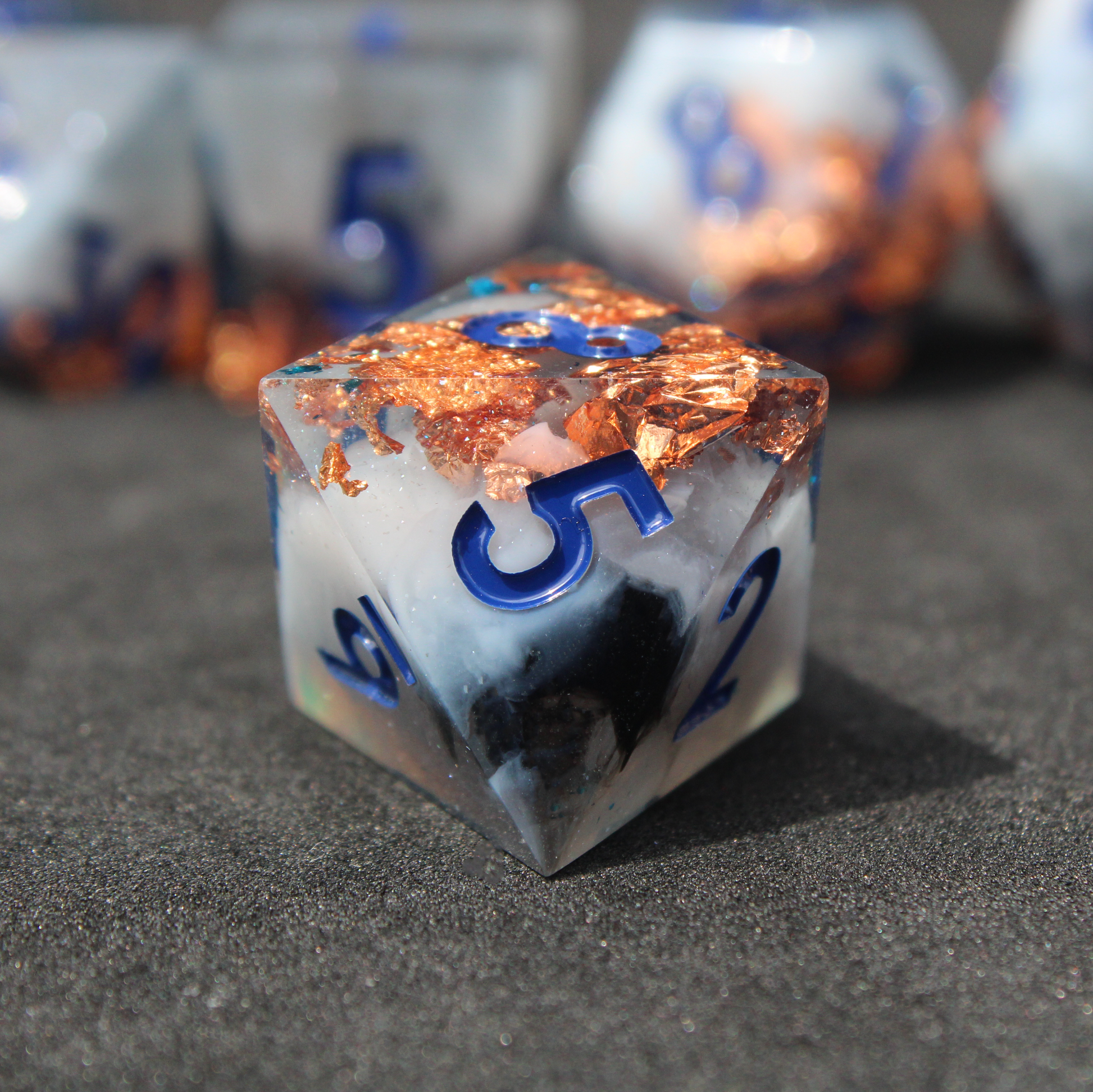 Blue grey sharp edge dnd dice used for playing tabletop roleplaying games like Dungeons & Dragons / D&D and Pathfinder. 