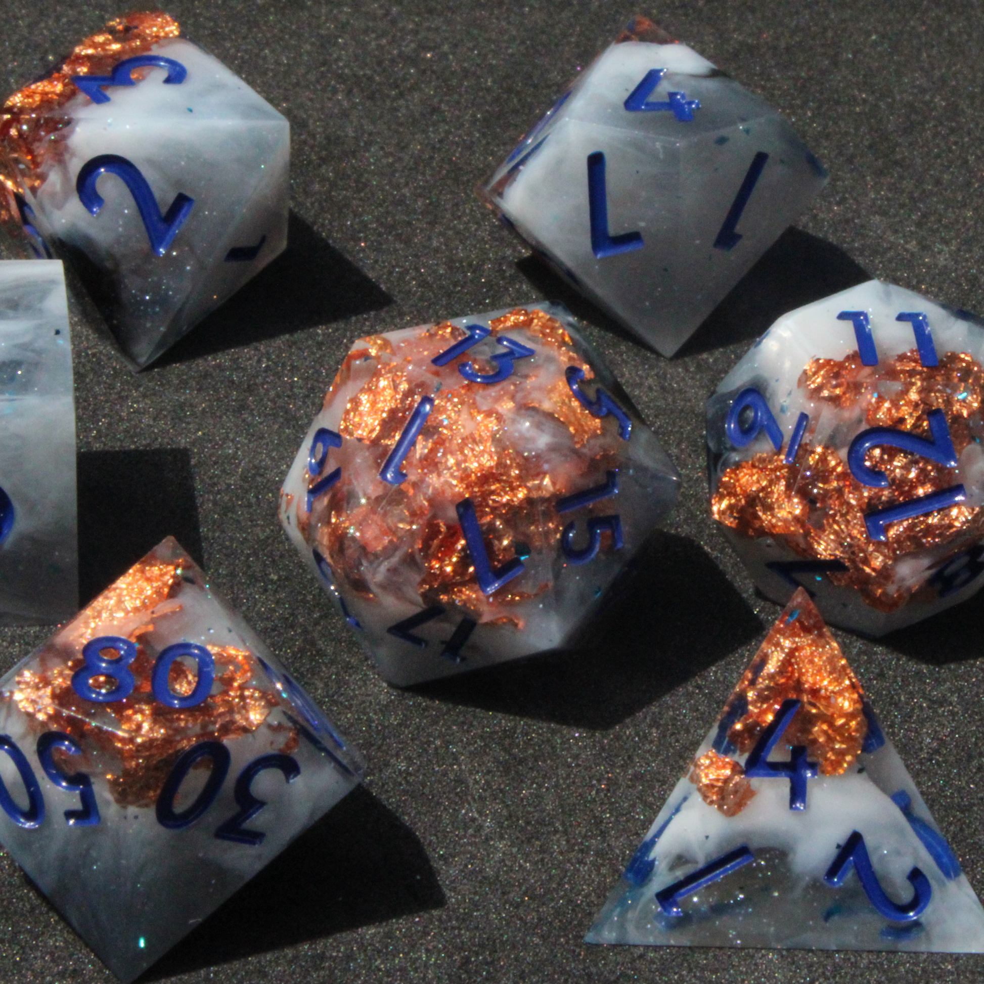 Blue grey sharp edge dnd dice used for playing tabletop roleplaying games like Dungeons & Dragons / D&D and Pathfinder. 