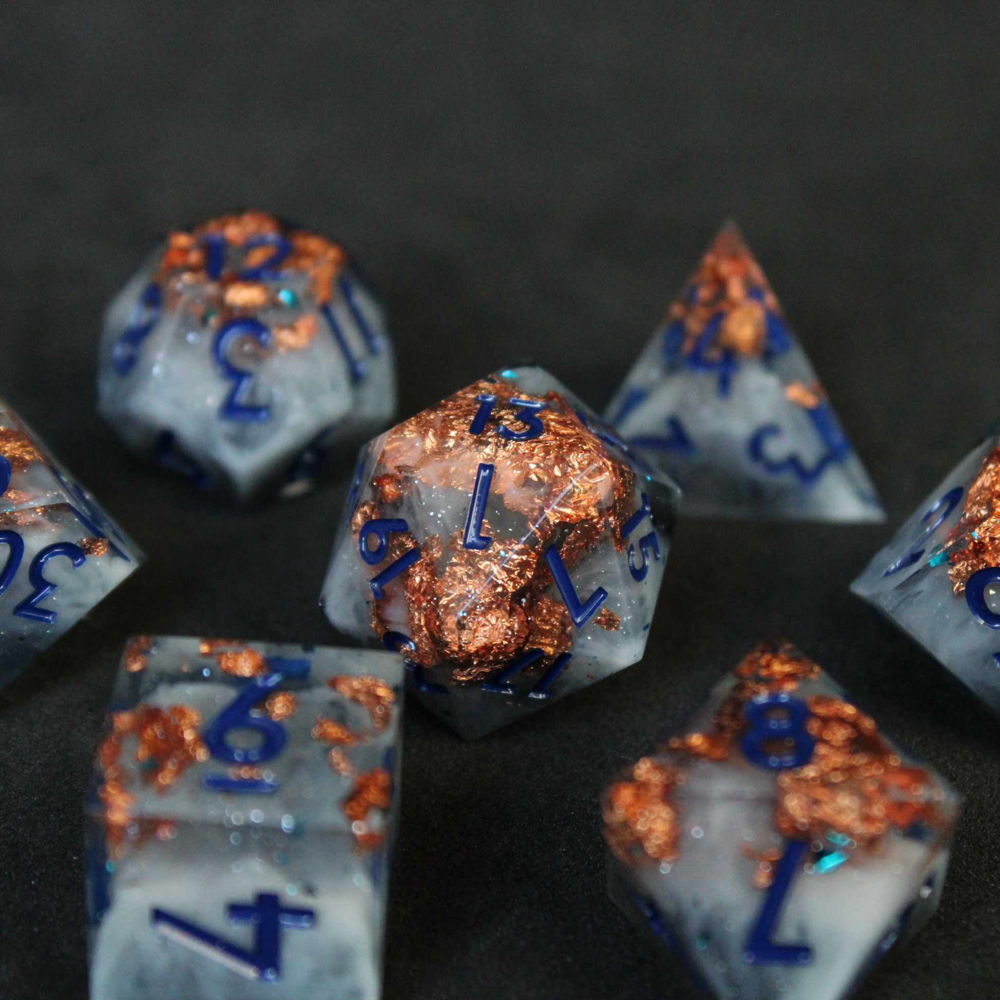 Blue grey sharp edge dnd dice used for playing tabletop roleplaying games like Dungeons & Dragons / D&D and Pathfinder. 