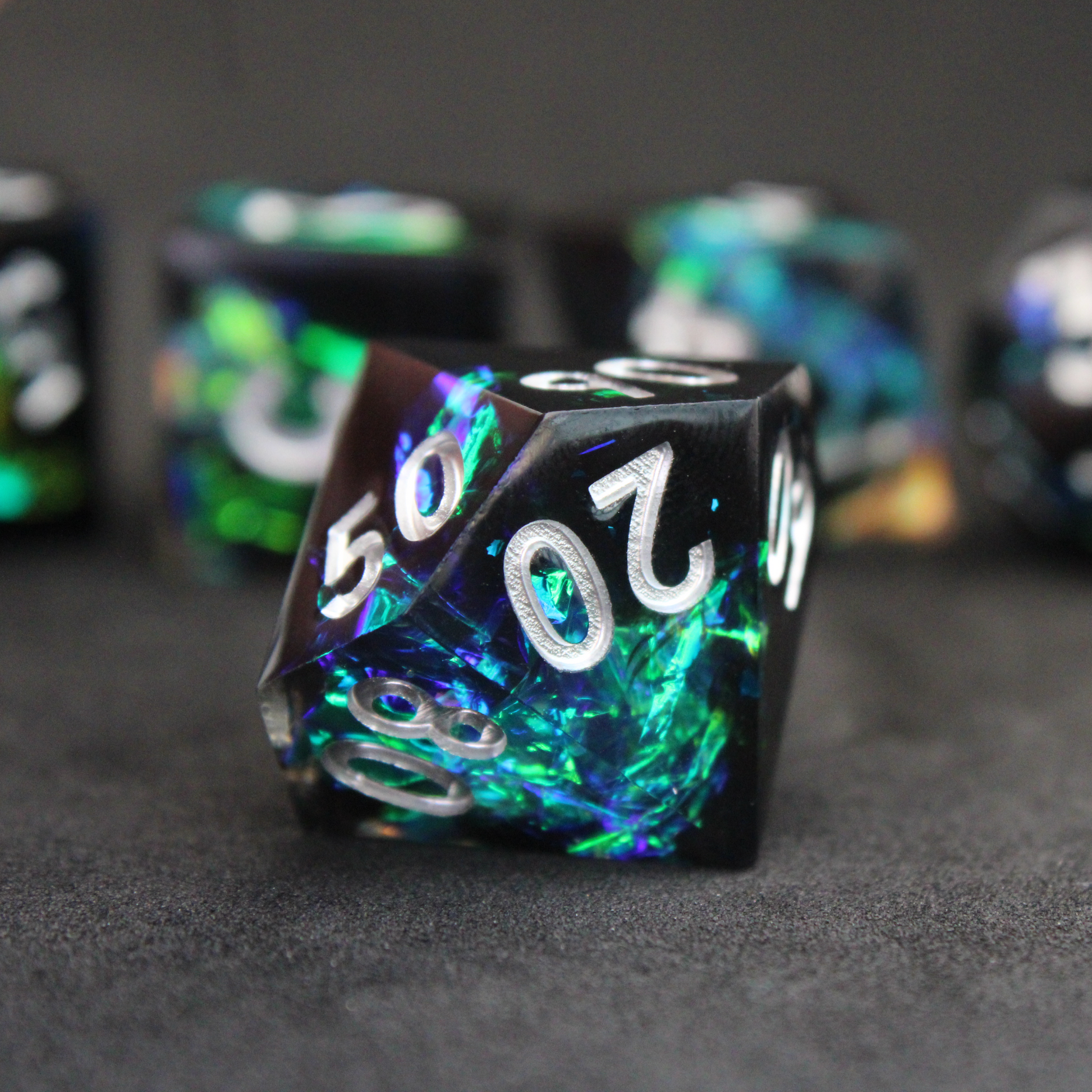 Black and blue sharp edge dnd dice set made of resin and made to look like lightning in a bottle. These polyhedral dice are used to play TTRPGs like Dungeons & Dragons / D&D and Pathfinder.