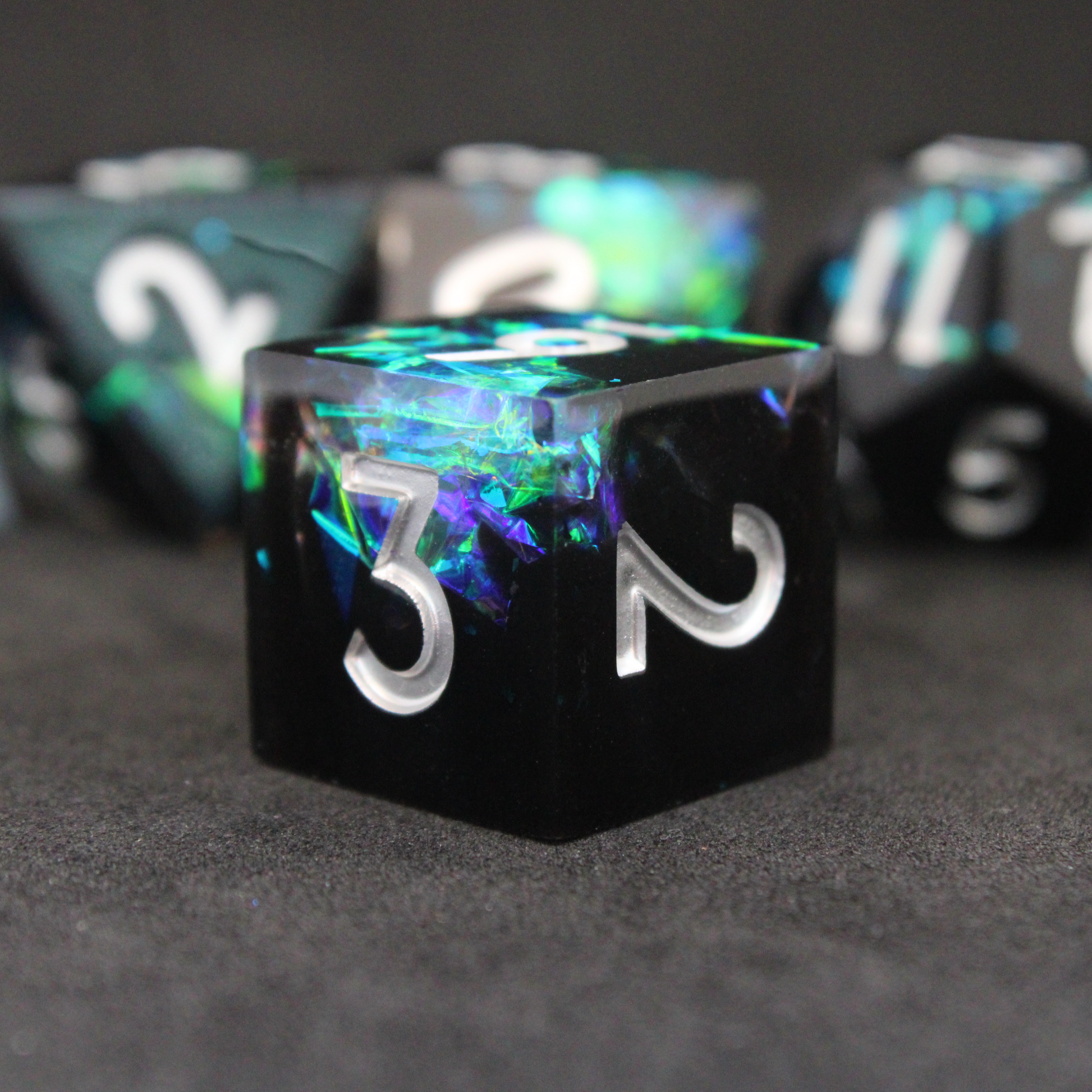 Black and blue sharp edge dnd dice set made of resin and made to look like lightning in a bottle. These polyhedral dice are used to play TTRPGs like Dungeons & Dragons / D&D and Pathfinder.