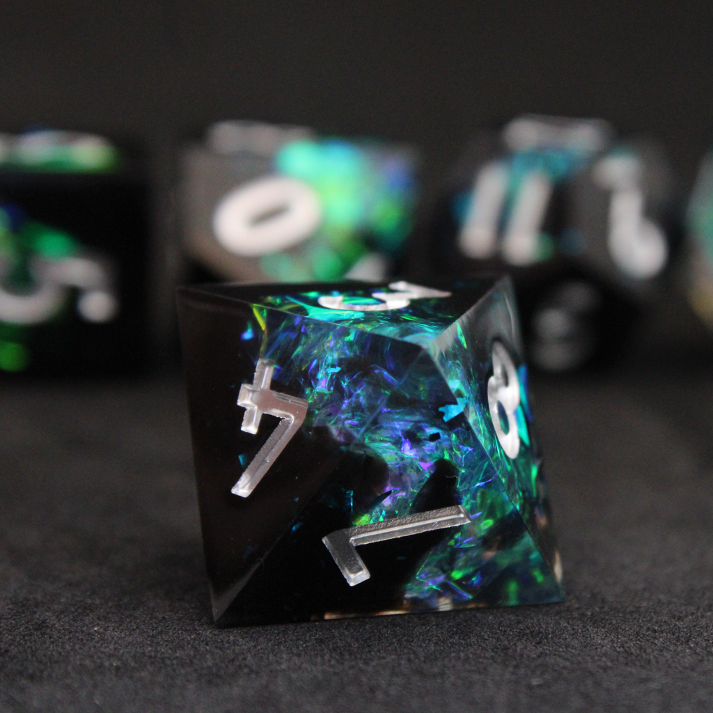 Black and blue sharp edge dnd dice set made of resin and made to look like lightning in a bottle. These polyhedral dice are used to play TTRPGs like Dungeons & Dragons / D&D and Pathfinder.