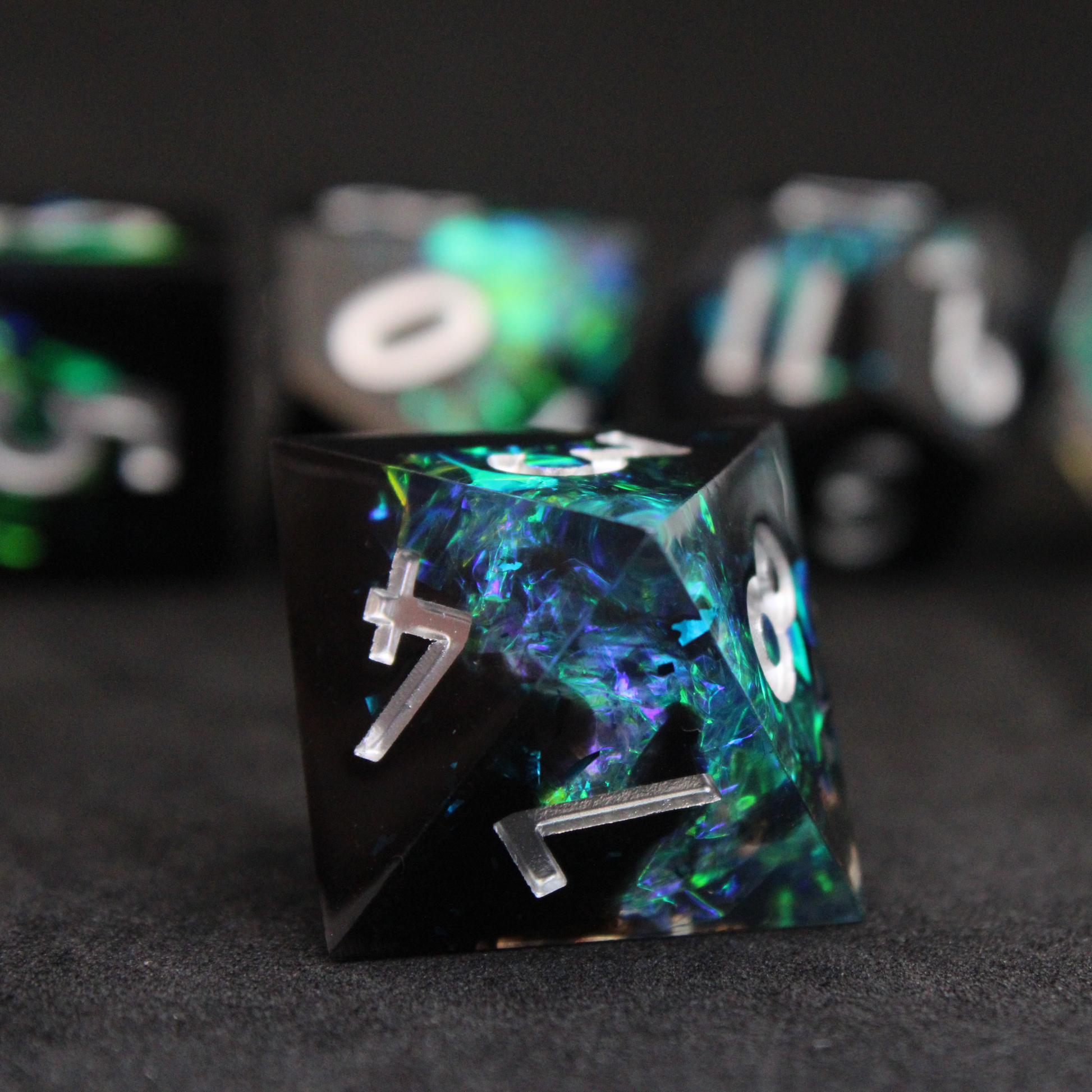 Black and blue sharp edge dnd dice set made of resin and made to look like lightning in a bottle. These polyhedral dice are used to play TTRPGs like Dungeons & Dragons / D&D and Pathfinder.