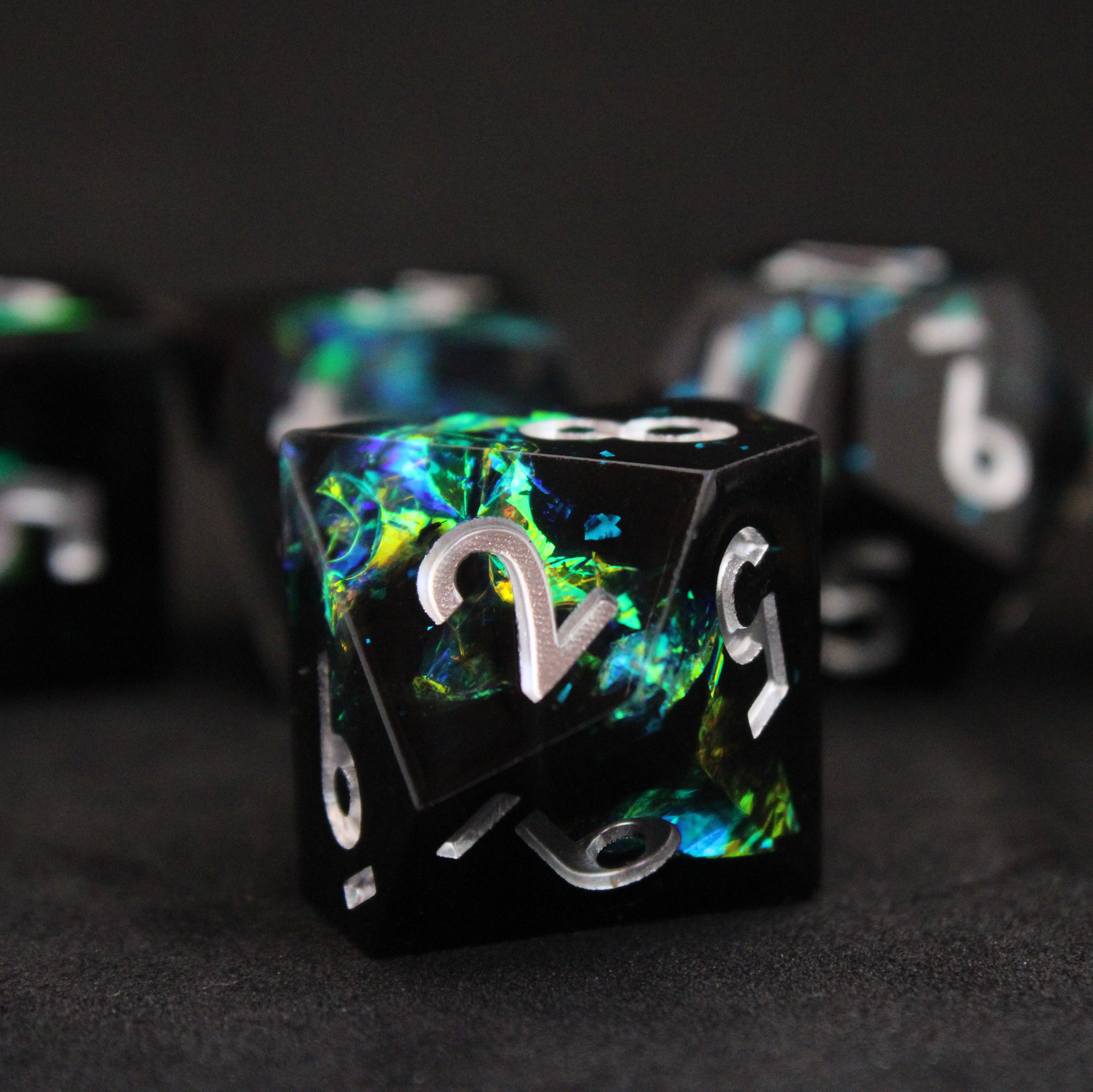 Black and blue sharp edge dnd dice set made of resin and made to look like lightning in a bottle. These polyhedral dice are used to play TTRPGs like Dungeons & Dragons / D&D and Pathfinder.