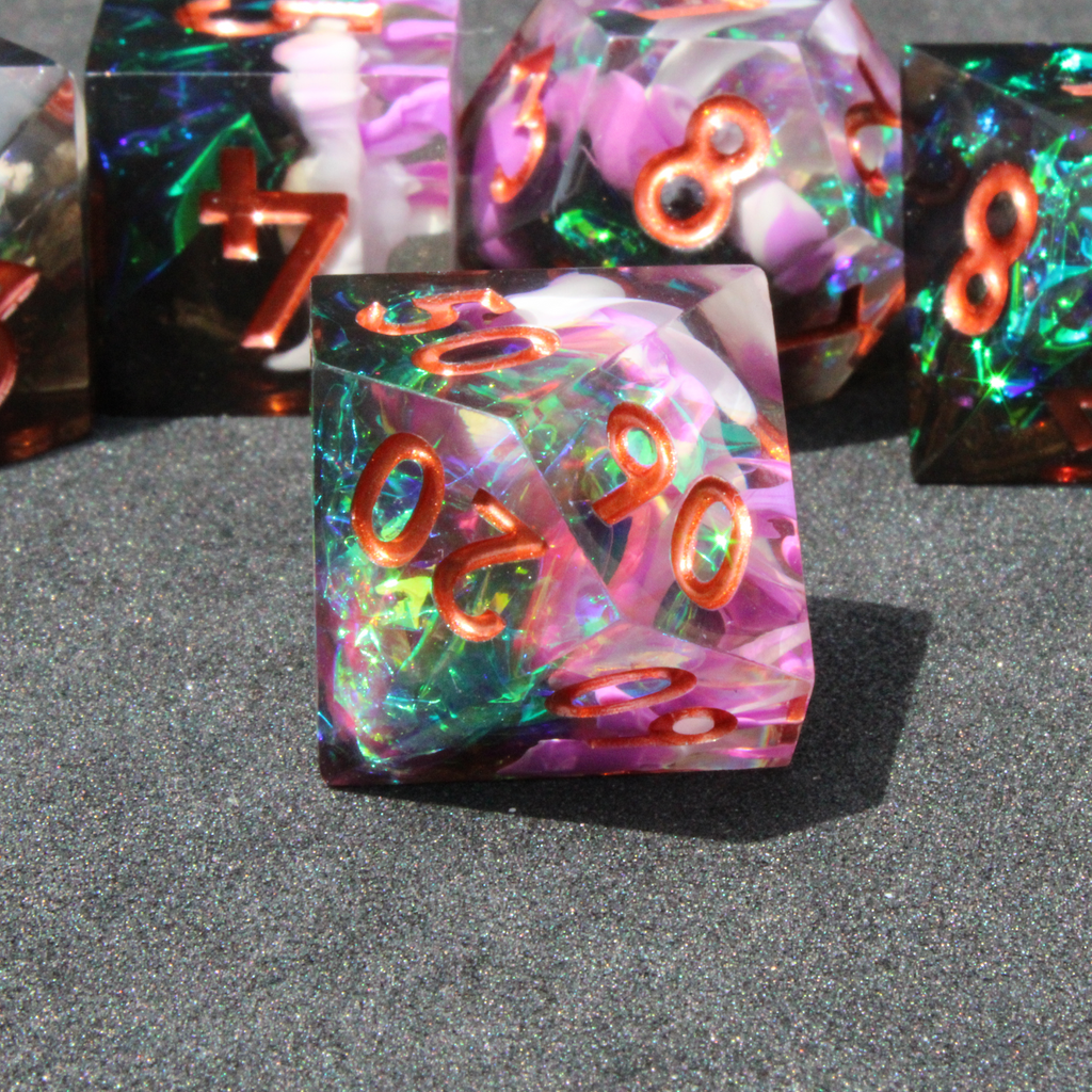 Purple and black resin dnd sharp edge dice. These polyhedral dice are used to play TTRPGs like Dungeons & Dragons / D&D and Pathfinder.