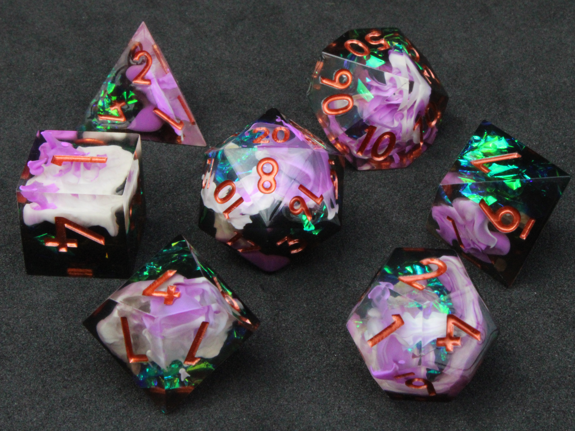 Purple and black resin dnd sharp edge dice. These polyhedral dice are used to play TTRPGs like Dungeons & Dragons / D&D and Pathfinder.