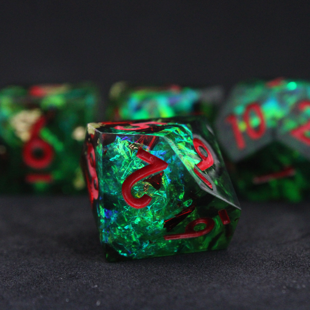 Green resin DND dice with red and blue holographic foils. These polyhedral dice are used in TTRPGs like Dungeons & Dragons / D&D and Pathfinder.