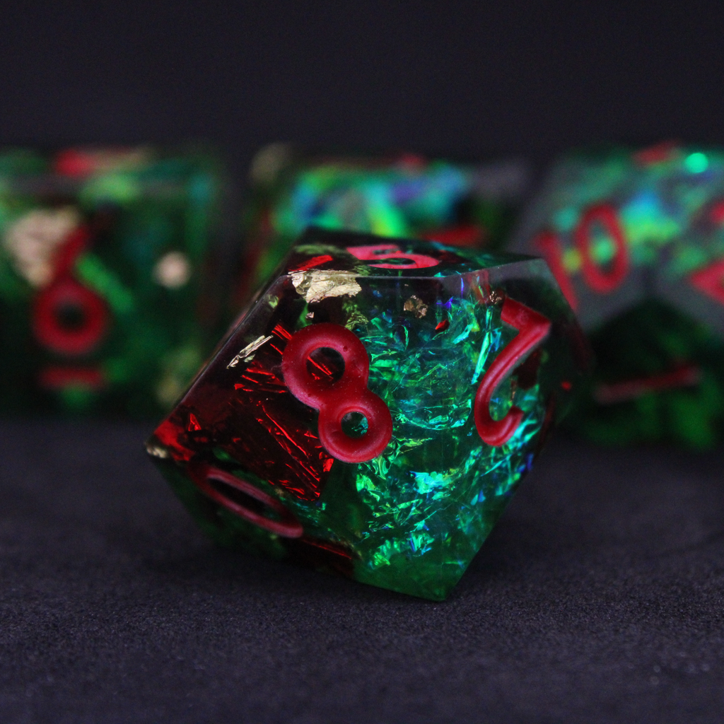 Green resin DND dice with red and blue holographic foils. These polyhedral dice are used in TTRPGs like Dungeons & Dragons / D&D and Pathfinder.