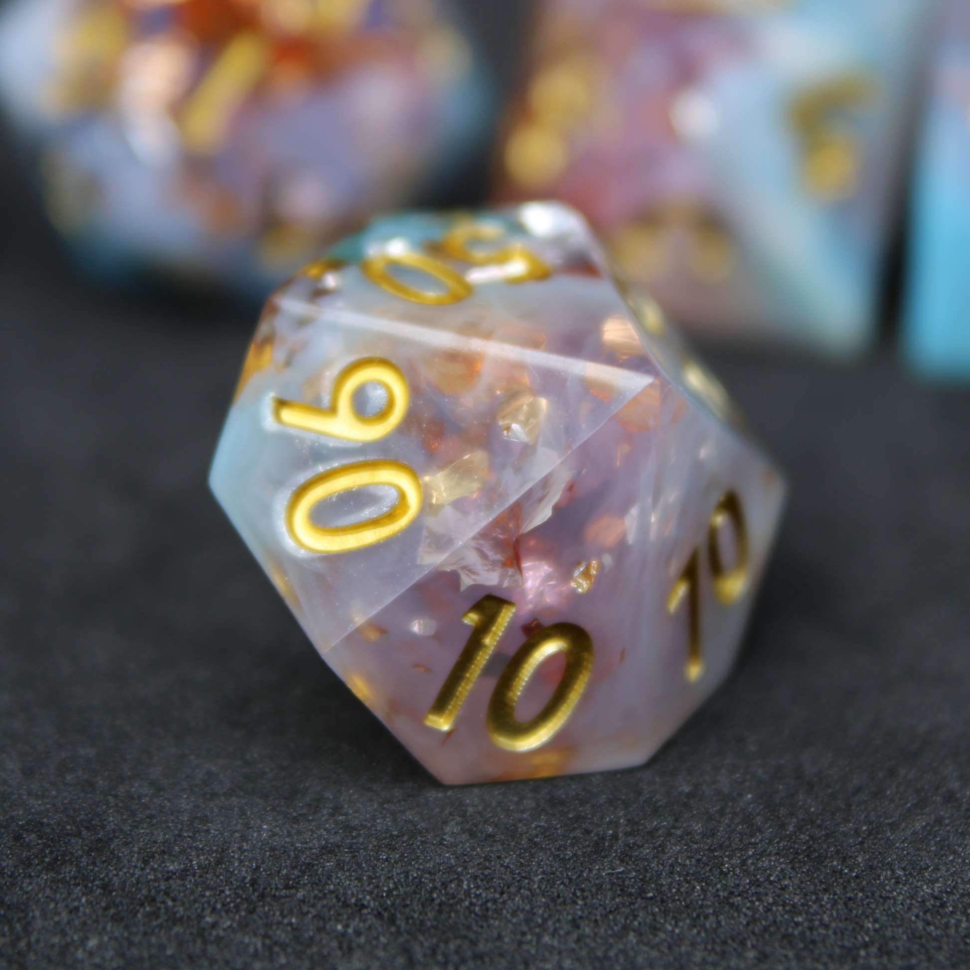 Blue and pink sharp edge dnd dice resembling candy floss. These polyhedral dice are used for playing TTRPGs like Dungeons & Dragons / D&D and Pathfinder.
