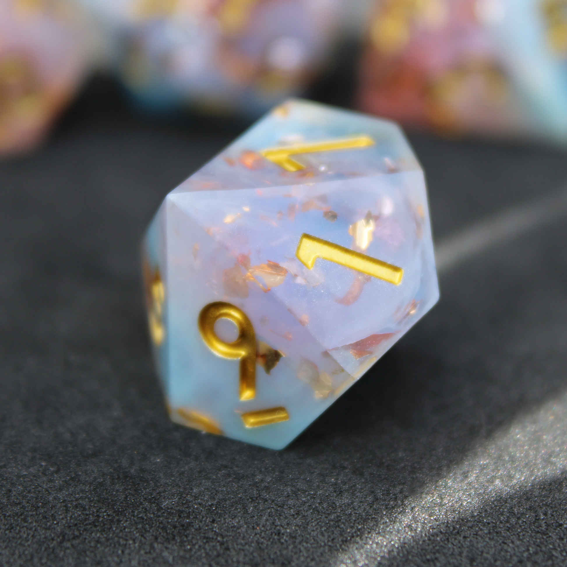Blue and pink sharp edge dnd dice resembling candy floss. These polyhedral dice are used for playing TTRPGs like Dungeons & Dragons / D&D and Pathfinder.