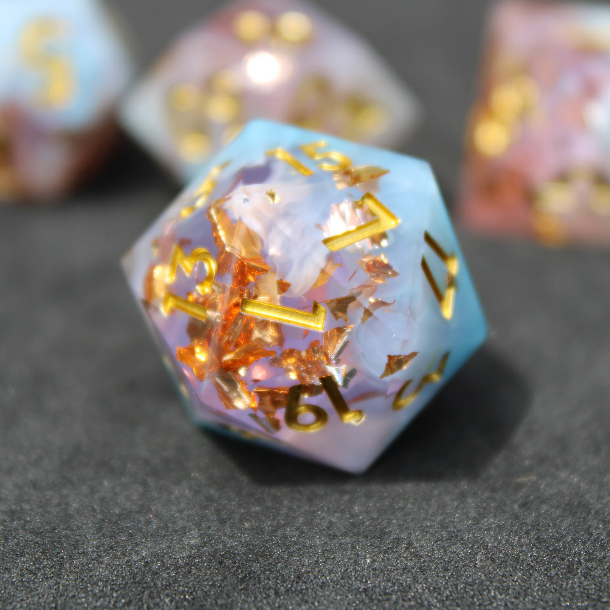 Blue and pink sharp edge dnd dice resembling candy floss. These polyhedral dice are used for playing TTRPGs like Dungeons & Dragons / D&D and Pathfinder.
