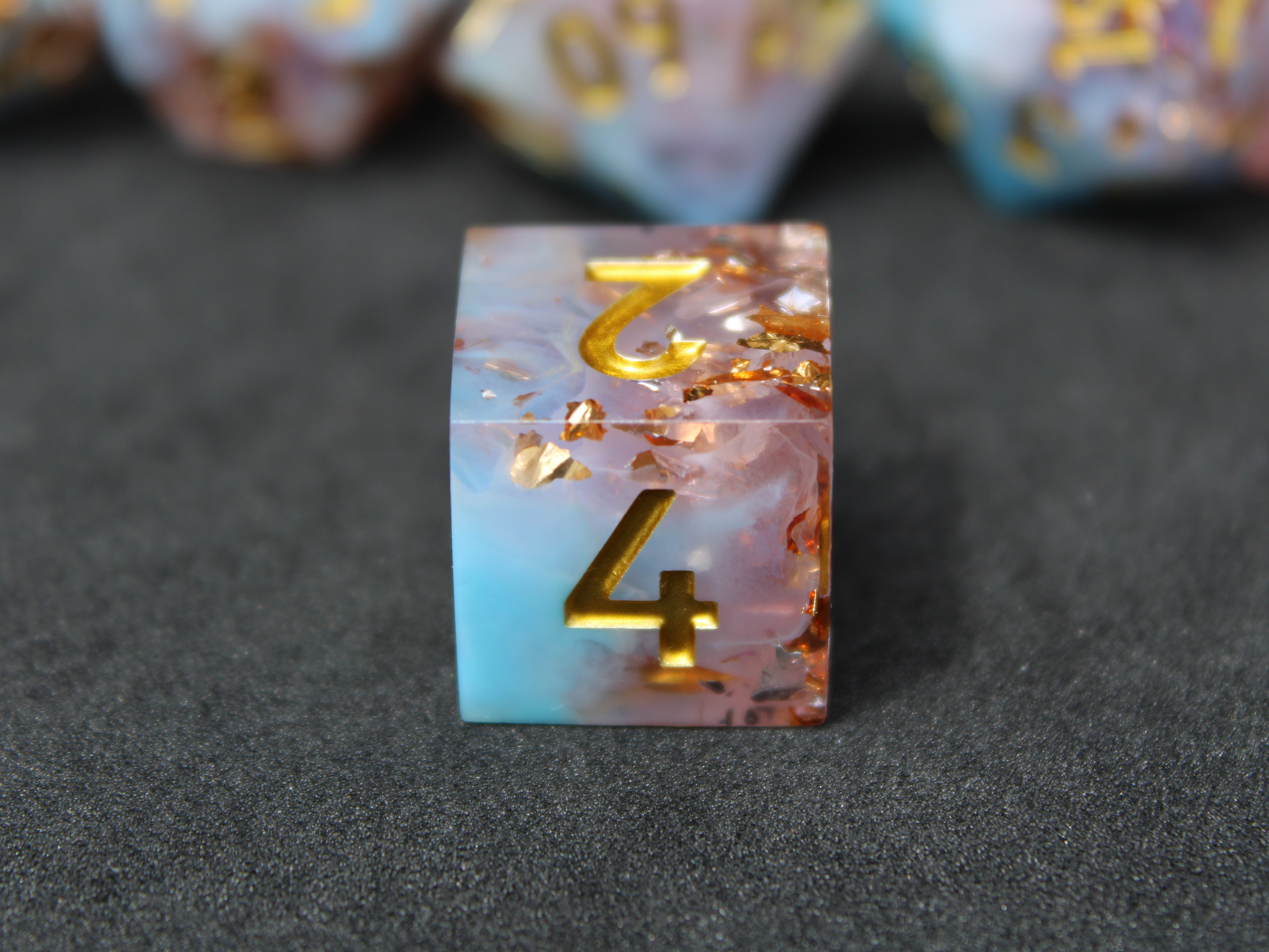 Blue and pink sharp edge dnd dice resembling candy floss. These polyhedral dice are used for playing TTRPGs like Dungeons & Dragons / D&D and Pathfinder.